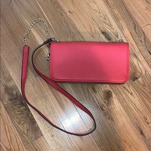 Red crossbody purse with gold chain accent